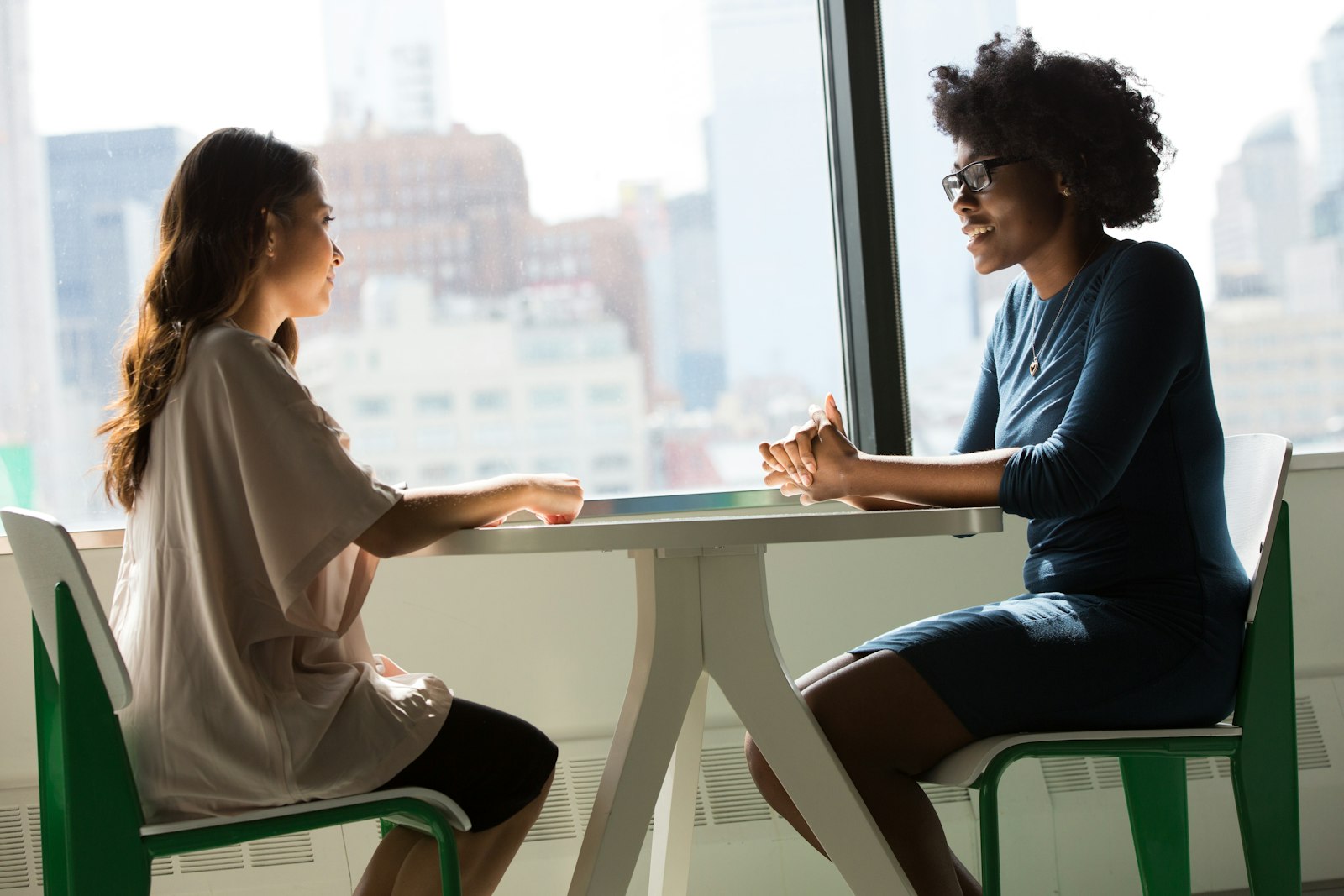 Two clinicians at a treatment facility review a multidimensional patient assessment form together at a conference table.